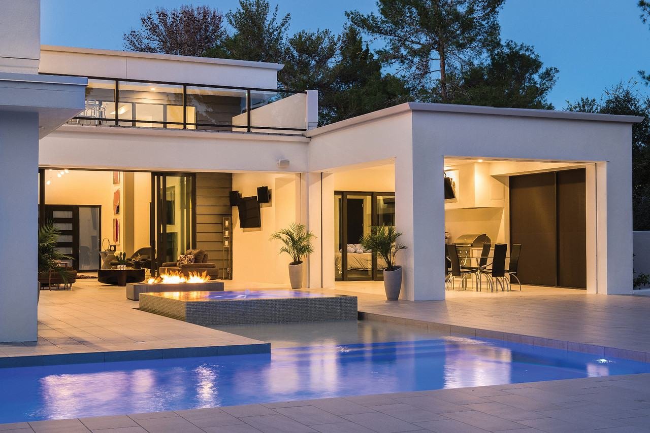 Pool and backyard lit at dusk